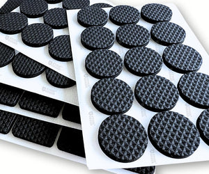A sheet of non-slip furniture rubber pads arranged in rows, with some pads already adhered to a white surface.different shapes in one pack